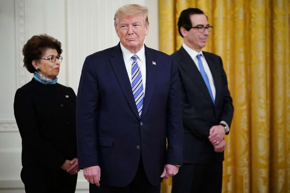 PHOTO: President Donald Trump is flanked by Small Business Administration Administrator Jovita Carranza, left, and Treasury Secretary Steven Mnuchin during a press briefing about the Paycheck Protection Program at the White House, April 28, 2020.