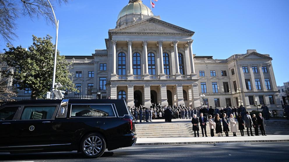 PHOTO: The hearse carrying the flag-draped casket of former President Jimmy Carter pauses outside the State Capitol in Atlanta, on Jan. 4, 2025. 