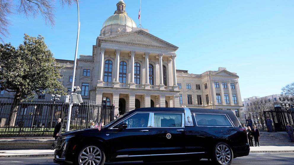 PHOTO: The hearse carrying the flag-draped casket of former President Jimmy Carter pauses outside the State Capitol in Atlanta, Jan. 4, 2025. 