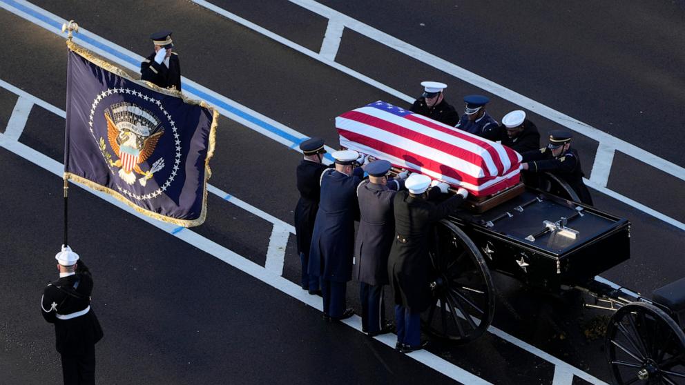 PHOTO: The flag-draped casket of former President Jimmy Carter is transferred to a horse-drawn caisson at the US Navy Memorial before traveling on to the Capitol in Washington, DC, on January 7, 2025, where Carter will lie in state. 
