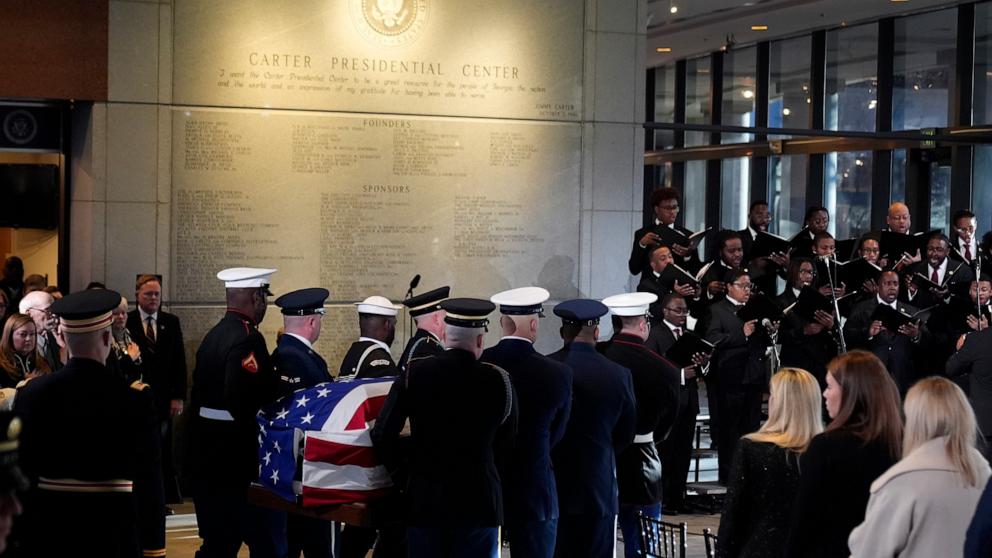 PHOTO: As the Morehouse College Glee Club sings, a military body bear teams moves the flag-draped casket of former President Jimmy Carter at the Jimmy Carter Presidential Library and Museum in Atlanta, Jan. 4, 2025. 