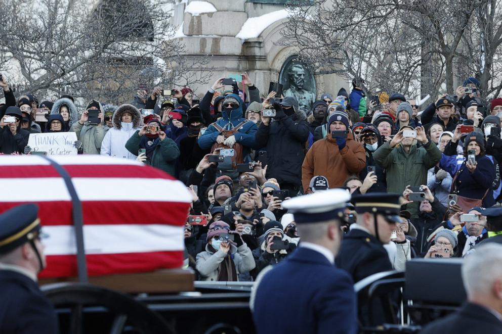 PHOTO: A horse-drawn caisson carries the flag-draped casket of former President Jimmy Carter as the State Funeral Procession departs the US Navy Memorial and heads to the Capitol in Washington, DC, on Jan. 7, 2025, where Carter will lie in state.