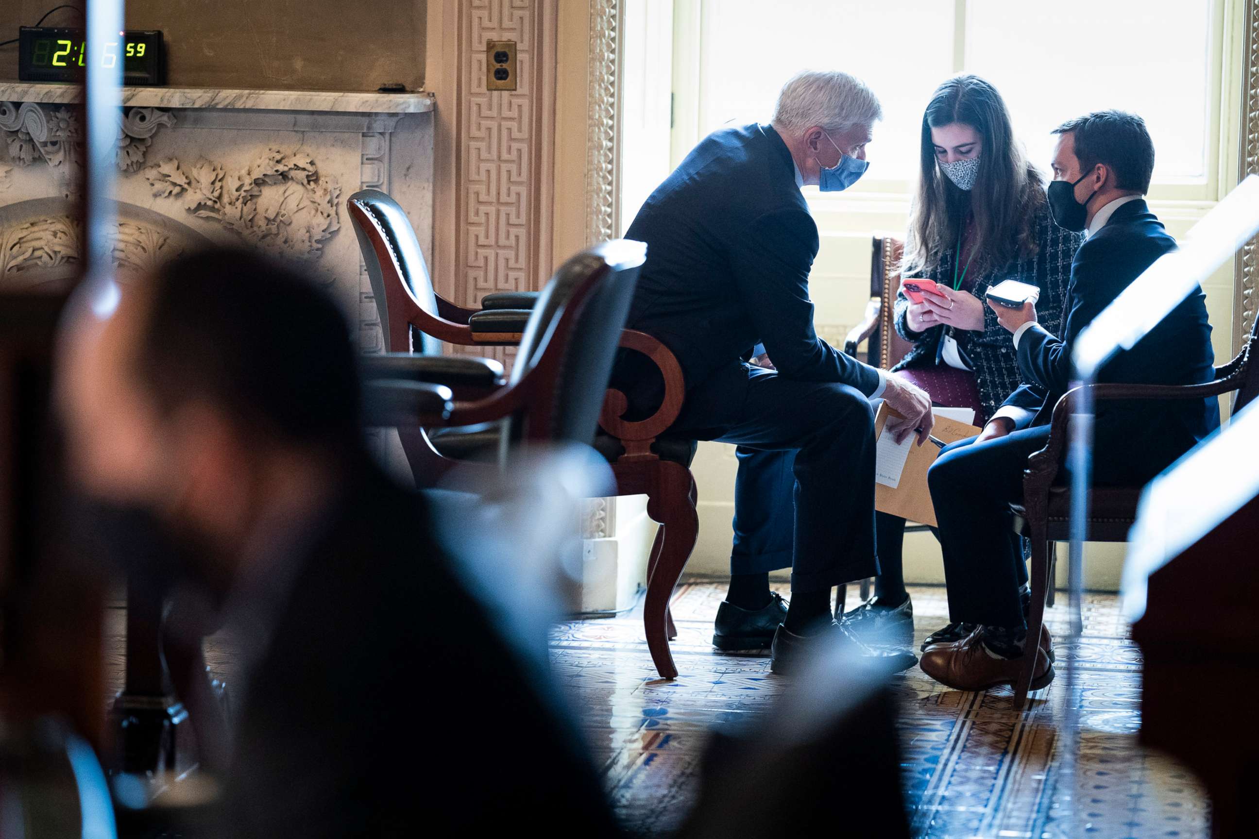 PHOTO: Sen. Bill Cassidy talks with staff in the Senate Reception room on the fourth day of the Senate Impeachment trials for former President Donald Trump on Capitol Hill on Feb. 12, 2021, in Washington, D.C.
