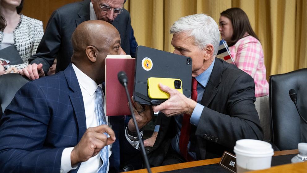 PHOTO: Senator Cassidy, (R-La.) and Senator Scott, (R-S.C.) speak during a Senate Finance Committee business meeting after voting to advance the nomination of Robert F. Kennedy Jr. to be Secretary of Health and Human Services in Washington, Feb. 4, 2025.