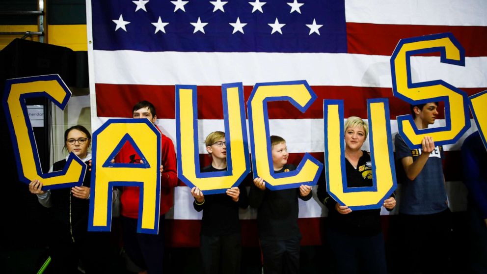 PHOTO: Attendees hold letters that read "CAUCUS" during a campaign event for Democratic presidential candidate former South Bend, Ind., Mayor Pete Buttigieg at Northwest Junior High, in Coralville, Iowa, Feb. 2, 2020.