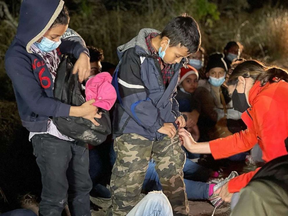 PHOTO: ABC News' Cecilia Vega speaks with two young boys who were traveling alone while attempting to reach relatives in the United States, at the U.S. Border in March 2021.