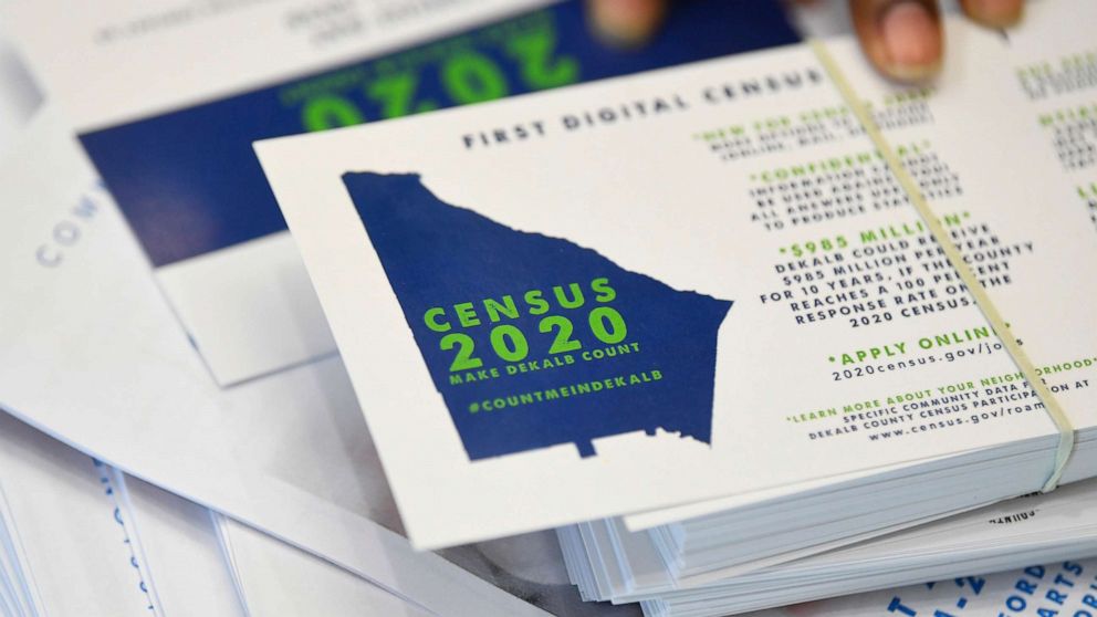 In this Aug. 13, 2019, file photo, a worker gets ready to pass out instructions in how fill out the 2020 census during a town hall meeting in Lithonia, Ga.