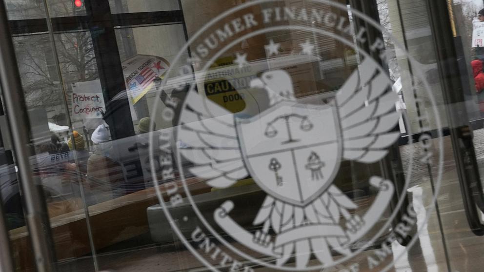PHOTO: Demonstrators take part in a protest by the Consumer Financial Protection Bureau (CFPB) building, the day after members of Elon Musk's Department of Government Efficiency (DOGE) moved into the CFPB, in Washington, DC, Feb. 8, 2025. 