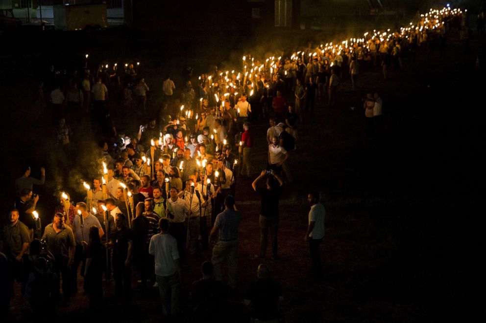 PHOTO: Neo Nazis, Alt-Right, and White Supremacists march through the University of Virginia Campus with torches in Charlottesville, Va., USA on August 11, 2017.