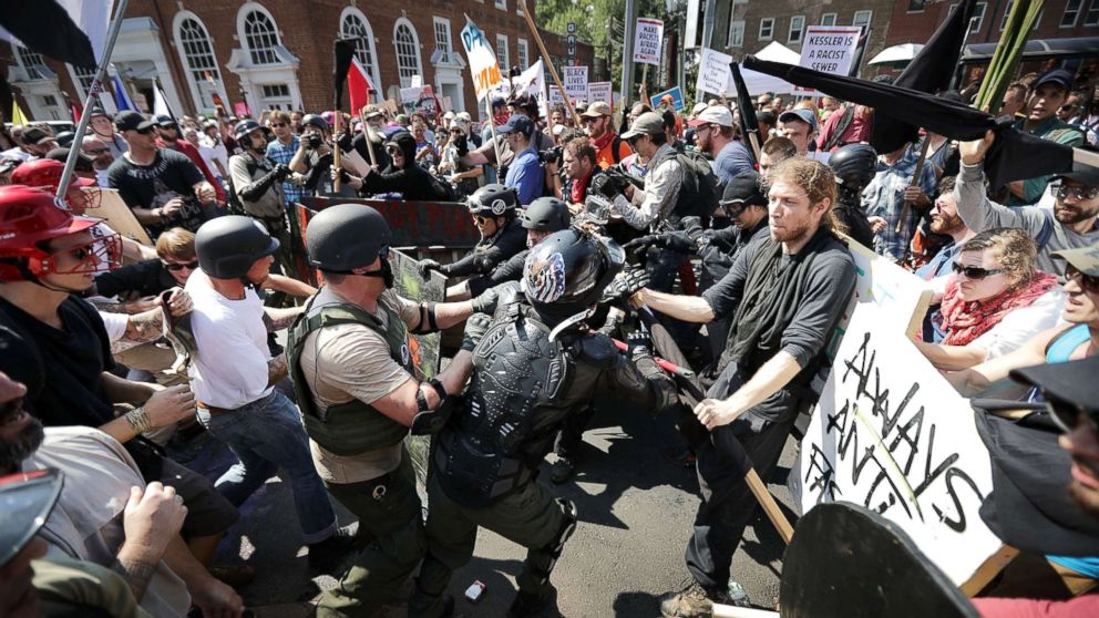 PHOTO: White nationalists, neo-Nazis and members of the "so-called alt-right" clash with counter-protesters as they enter Lee Park during a rally on Aug. 12, 2017 in Charlottesville, Va. 