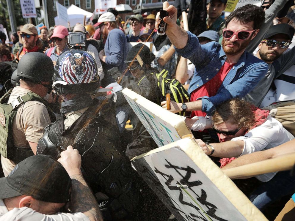 PHOTO: White nationalists exchange volleys of pepper spray with counterprotesters as they enter Lee Park during the Unite the Right rally on Aug. 12, 2017, in Charlottesville, Va.