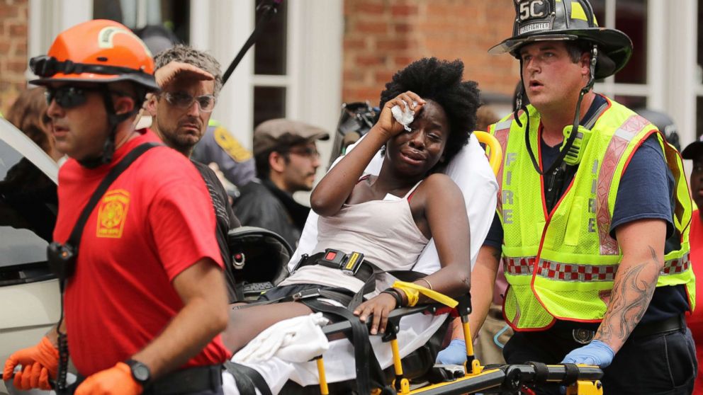 PHOTO: Rescue workers move victims on stretchers after car plowed through a crowd of counter-demonstrators marching through the downtown shopping district Aug. 12, 2017 in Charlottesville, Va.
