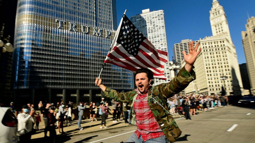 PHOTO: A supporter of President-elect Joe Biden celebrates while riding his bike outside Trump Tower, Nov. 7, 2020, in Chicago.