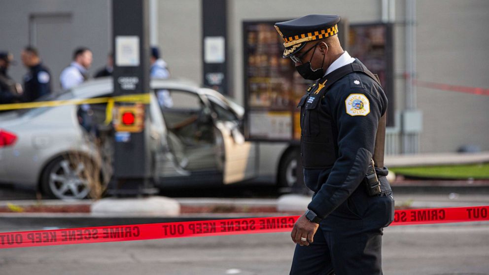 PHOTO: A police commander walks by as police investigate a crime scene where Jontae Adams, 28, and his daughter Jaslyn, 7, where shot, resulting in Jaslyn's death at a McDonald's drive-thru, April 18, 2021, in Chicago.