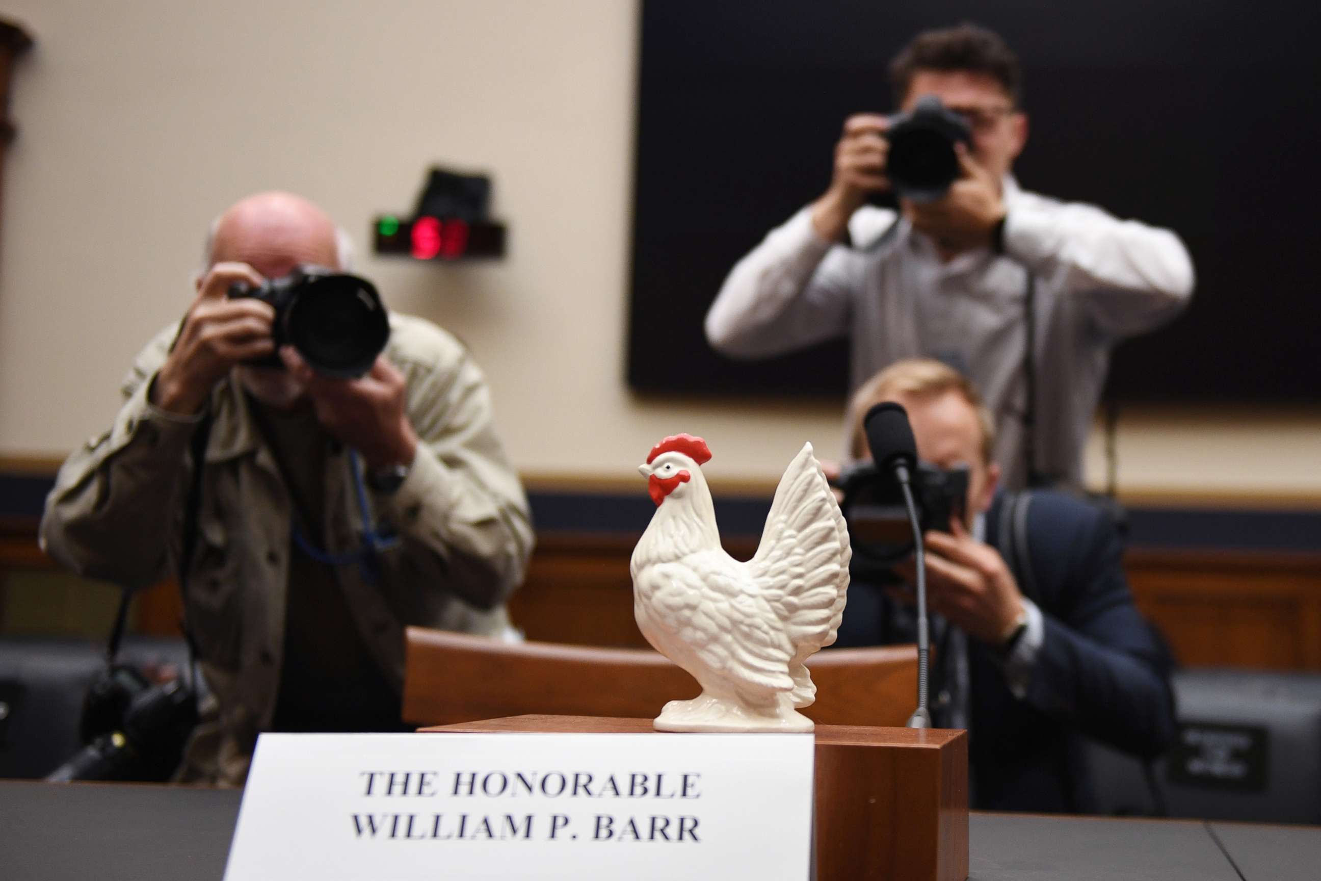 PHOTO: Photographers take a picture of a chicken placed on the empty seat for U.S. Attorney General Bill Barr in the House Judiciary Committee room on Capitol Hill in Washington, D.C., May 2, 2019.