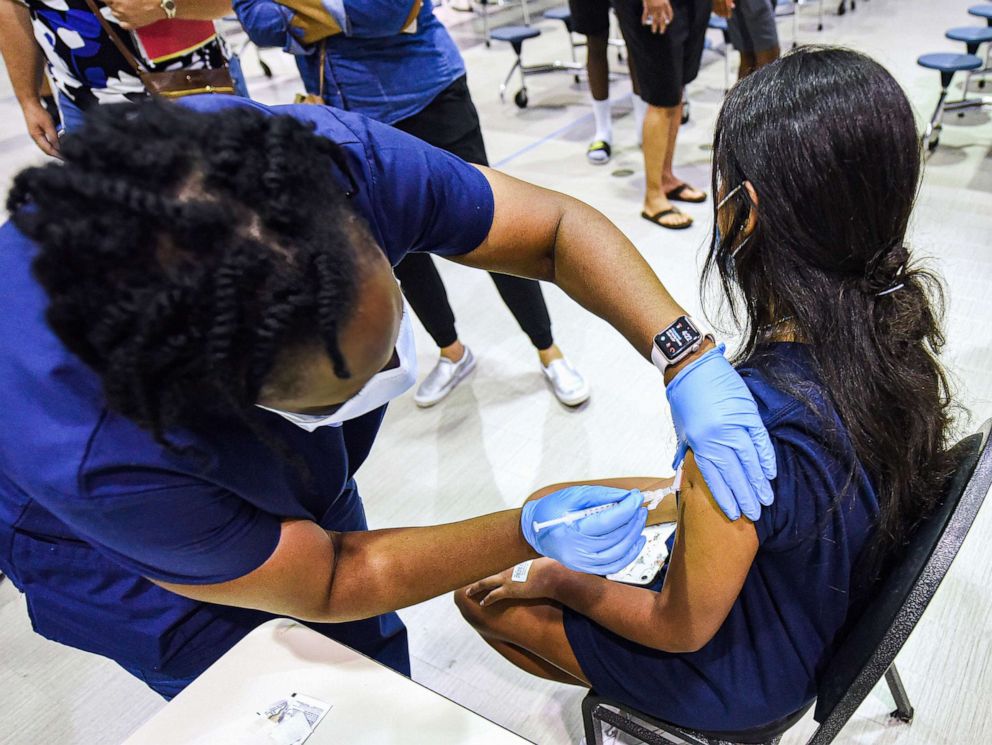 PHOTO: A nurse gives a girl a dose of the Pfizer vaccine at a COVID-19 vaccine clinic at Lyman High School in Longwood, Fla., Aug. 9, 2021. 