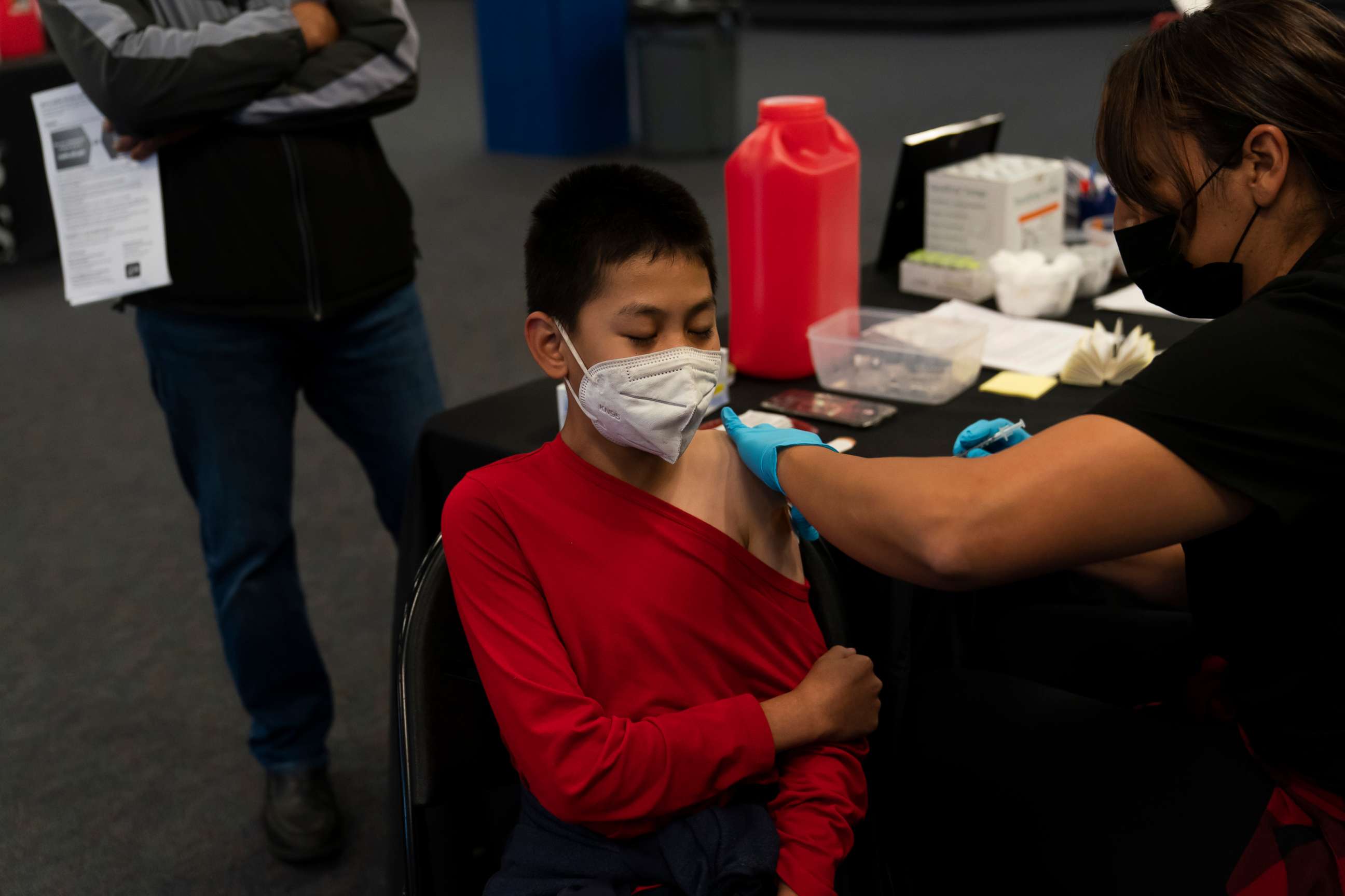 PHOTO: A youngster receives the Pfizer COVID-19 vaccine at a pediatric vaccine clinic for children ages 5 to 11 set up at Willard Intermediate School in Santa Ana, Calif., Nov. 9, 2021.