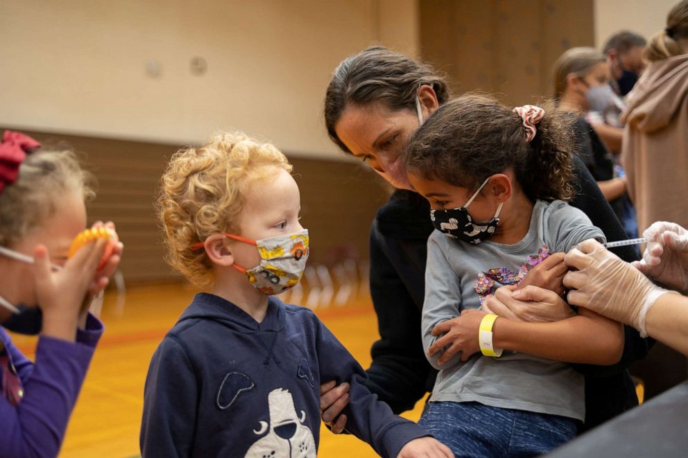 PHOTO: Coraline Carvalho, 6, receives the Pfizer coronavirus disease vaccine while being held by her mother in Collegeville, Pa., Nov. 6, 2021.