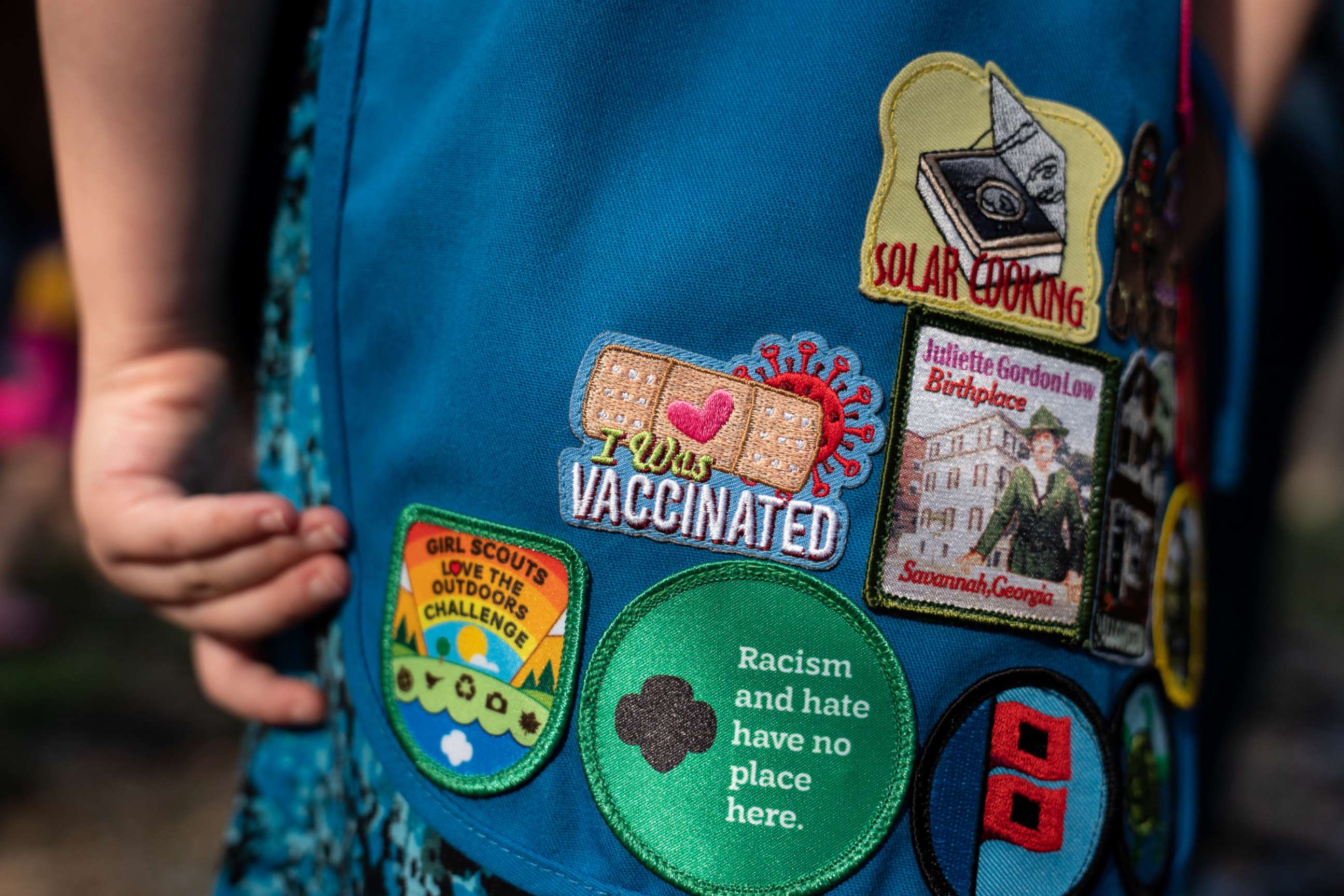 PHOTO: Naomi Macklom, 5, whose parents enrolled her and another daughter in a Pfizer-BioNTech COVID-19 vaccine trial, shows the "I was vaccinated" patch on her Girl Scout Brownie vest, in Cedar Park, Texas, Sept. 6, 2021.