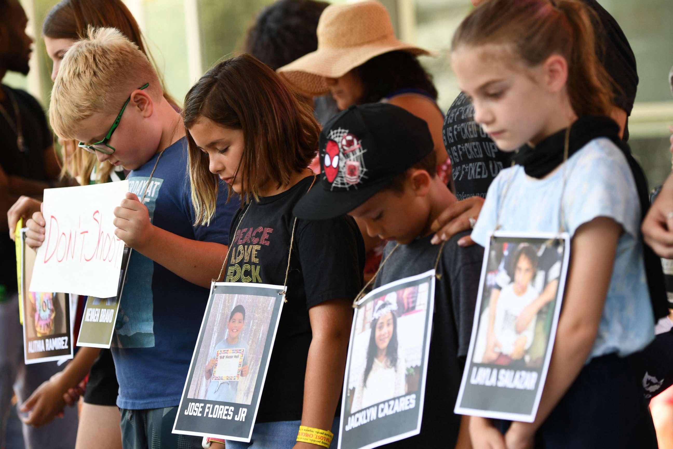 PHOTO: Children holding photos of victims of the Robb Elementary School shooting, participate in a minute of silence outside the National Rifle Association Annual Meeting at the George R. Brown Convention Center, on May 27, 2022, in Houston.