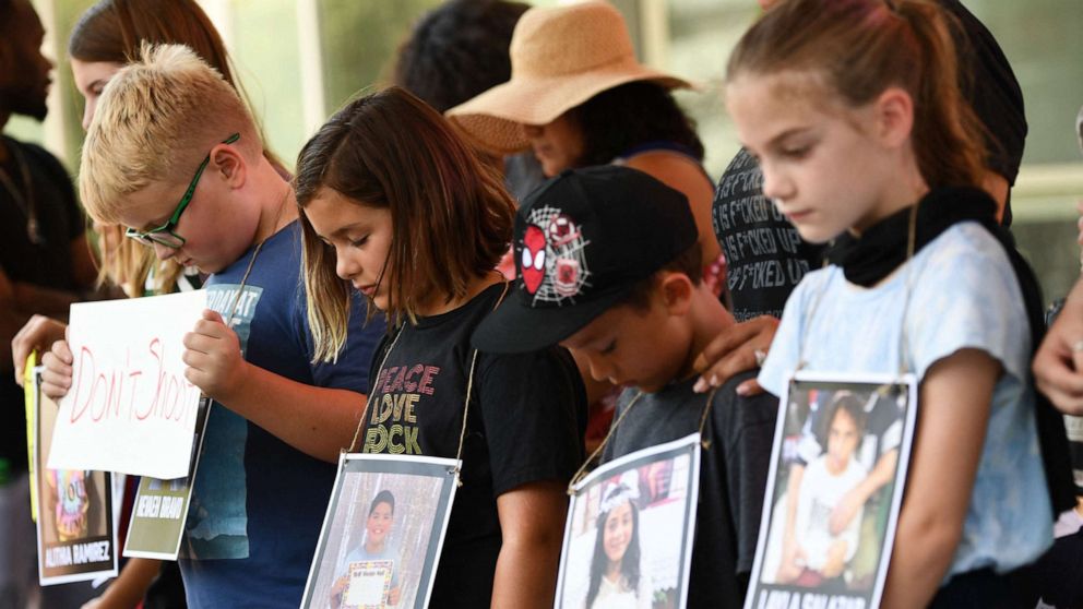 PHOTO: Children holding photos of victims of the Robb Elementary School shooting, participate in a minute of silence outside the National Rifle Association Annual Meeting at the George R. Brown Convention Center, on May 27, 2022, in Houston.