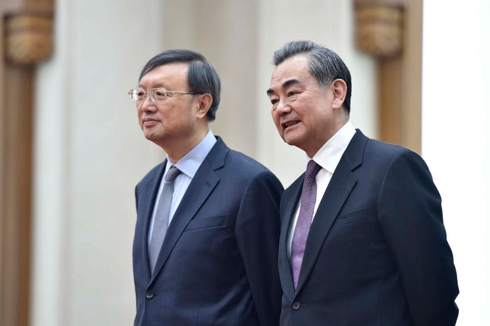 PHOTO: China's Foreign Minister Wang Yi, right, talks with China's State Councillor Yang Jiechi before a signing ceremony between Zimbabwe and China at the Great Hall of the People in Beijing, April 3, 2018.