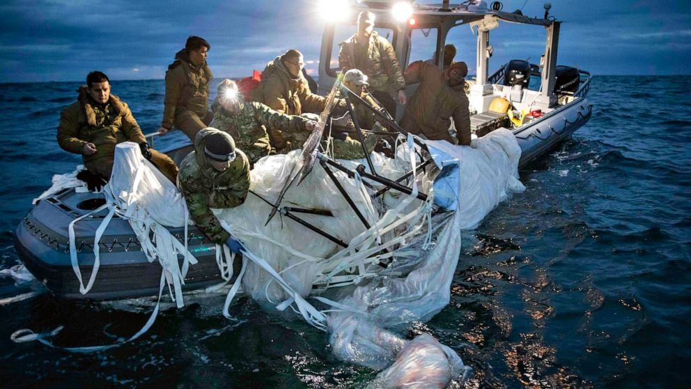 PHOTO: Sailors assigned to Explosive Ordnance Disposal Group 2 recover a high-altitude surveillance balloon off the coast of Myrtle Beach, S.C., Feb. 5, 2023, after it was shot down.