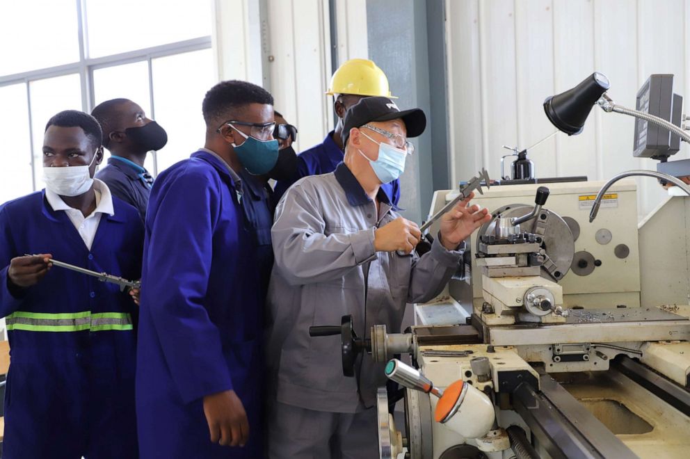 PHOTO: A Chinese instructor demonstrates measuring method to local trainees at the China-funded Uganda Industrial Research Institute at Namanve Industrial Park in Mukono district, Uganda, Nov. 9, 2021. 