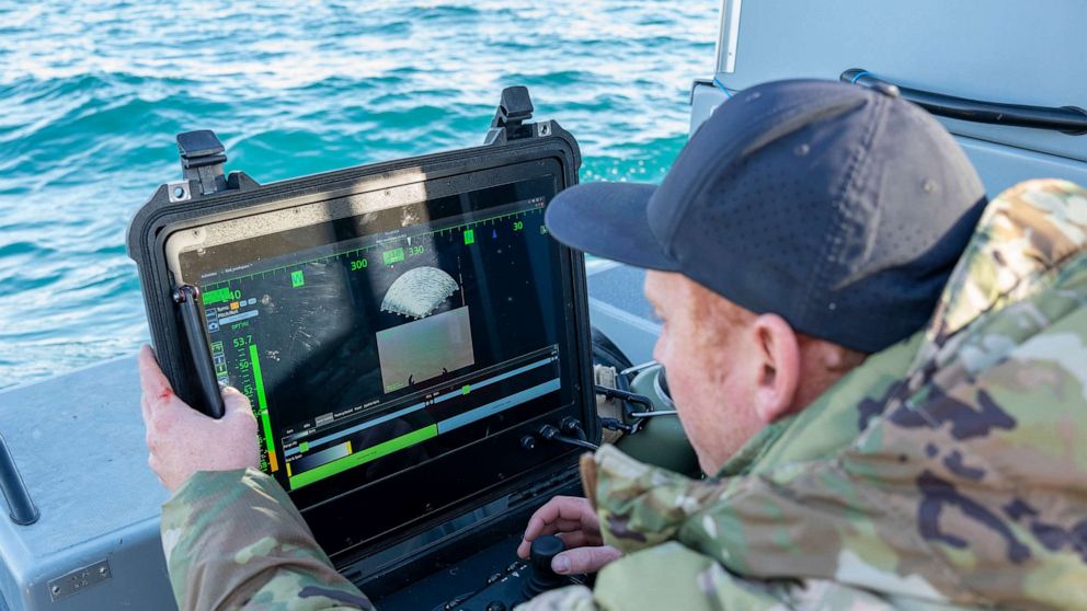 PHOTO: A Sailor assigned to Explosive Ordnance Disposal Group 2 conducts a search for debris with an underwater vehicle during recovery efforts of a high-altitude balloon in the Atlantic Ocean, Feb. 7, 2023.