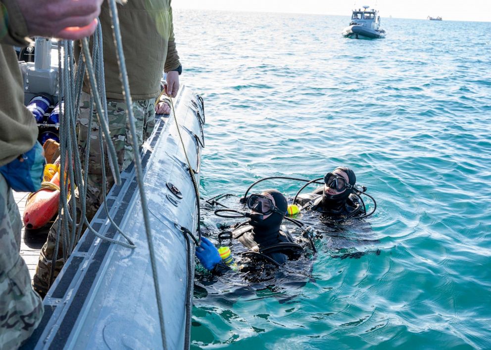 PHOTO: Sailors assigned to Explosive Ordnance Disposal Group 2 conduct pre-dive checks during recovery efforts of a high-altitude balloon in the Atlantic Ocean, Feb. 7, 2023.