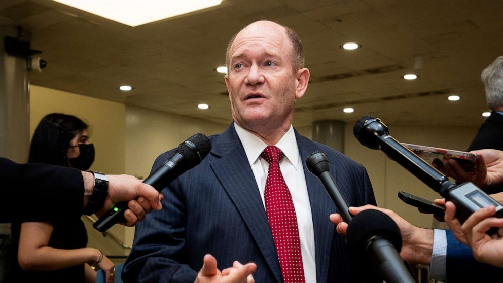 PHOTO: Sen. Chris Coons speaks with reporters near the Senate Subway at the U.S. Capitol.