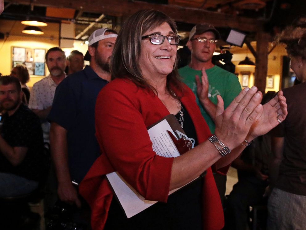 Vermont Democratic gubernatorial candidate Christine Hallquist, center, a transgender woman and former electric company executive, embraces supporters after claiming victory during her election night party in Burlington, Vt., Tuesday, Aug. 14, 2018.