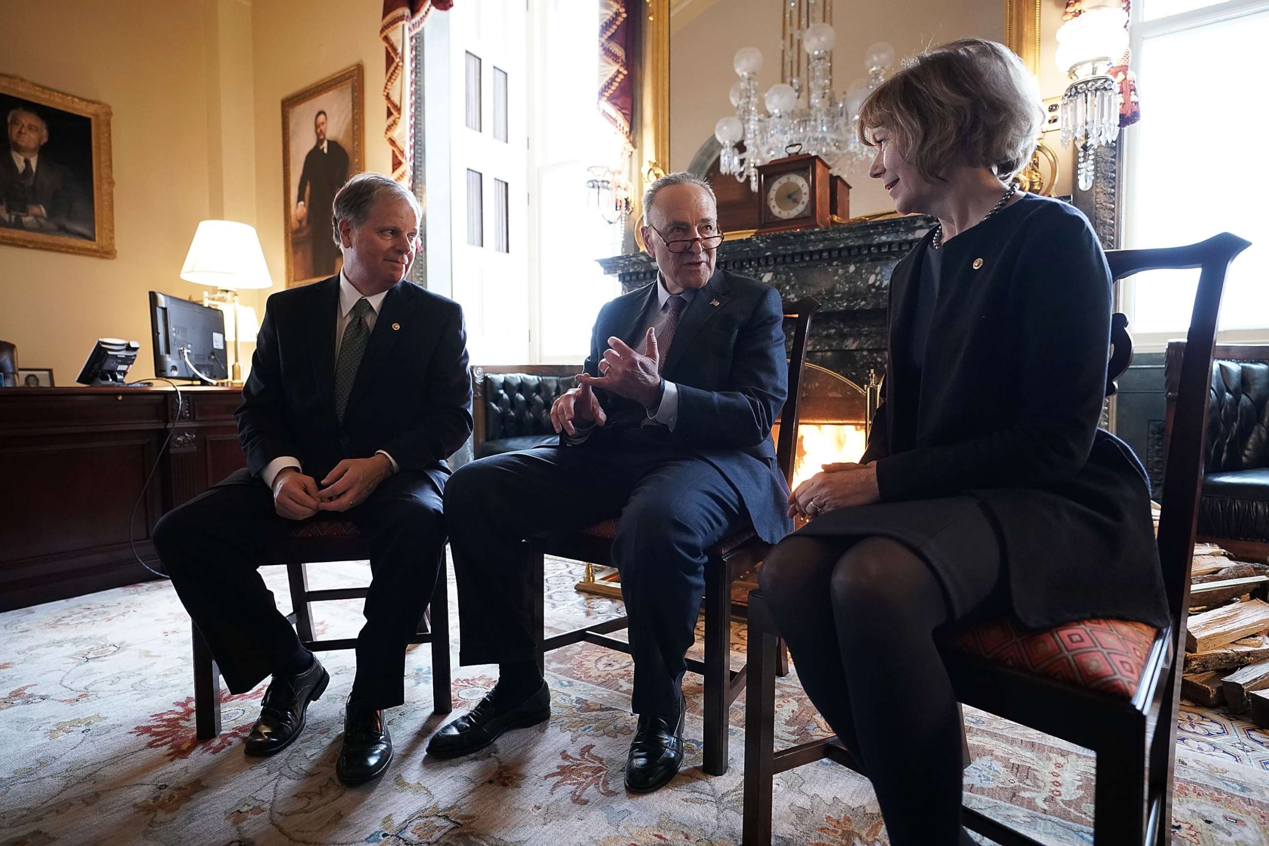 PHOTO: Senate Minority Leader Chuck Schumer, center, speaks to Sen. Doug Jones and Sen. Tina Smith during a meeting at the U.S. Capitol, Jan. 3, 2018, in Washington.