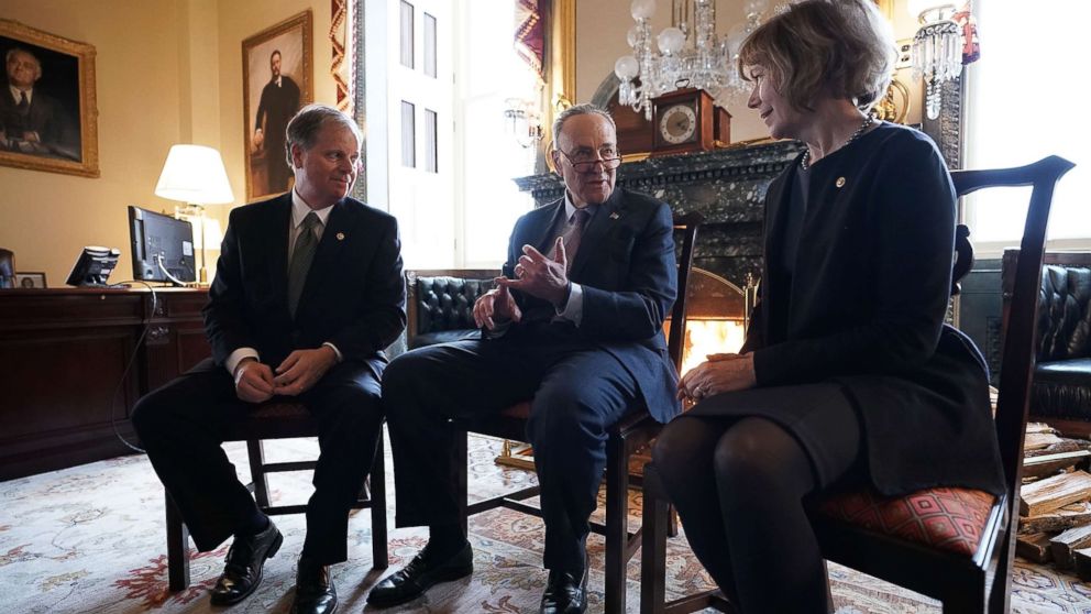 PHOTO: Senate Minority Leader Chuck Schumer, center, speaks to Sen. Doug Jones and Sen. Tina Smith during a meeting at the U.S. Capitol, Jan. 3, 2018, in Washington.