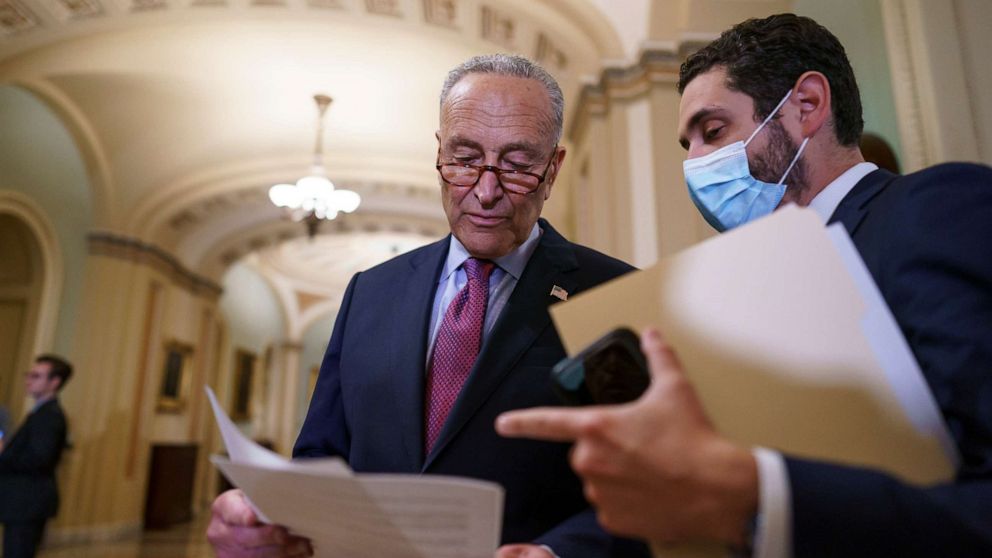 PHOTO: Senate Majority Leader Chuck Schumer, D-N.Y., looks over his notes as he talks to reporters about a procedural vote on the bipartisan infrastructure deal senators brokered with President Joe Biden, at the Capitol in Washington, July 20, 2021.