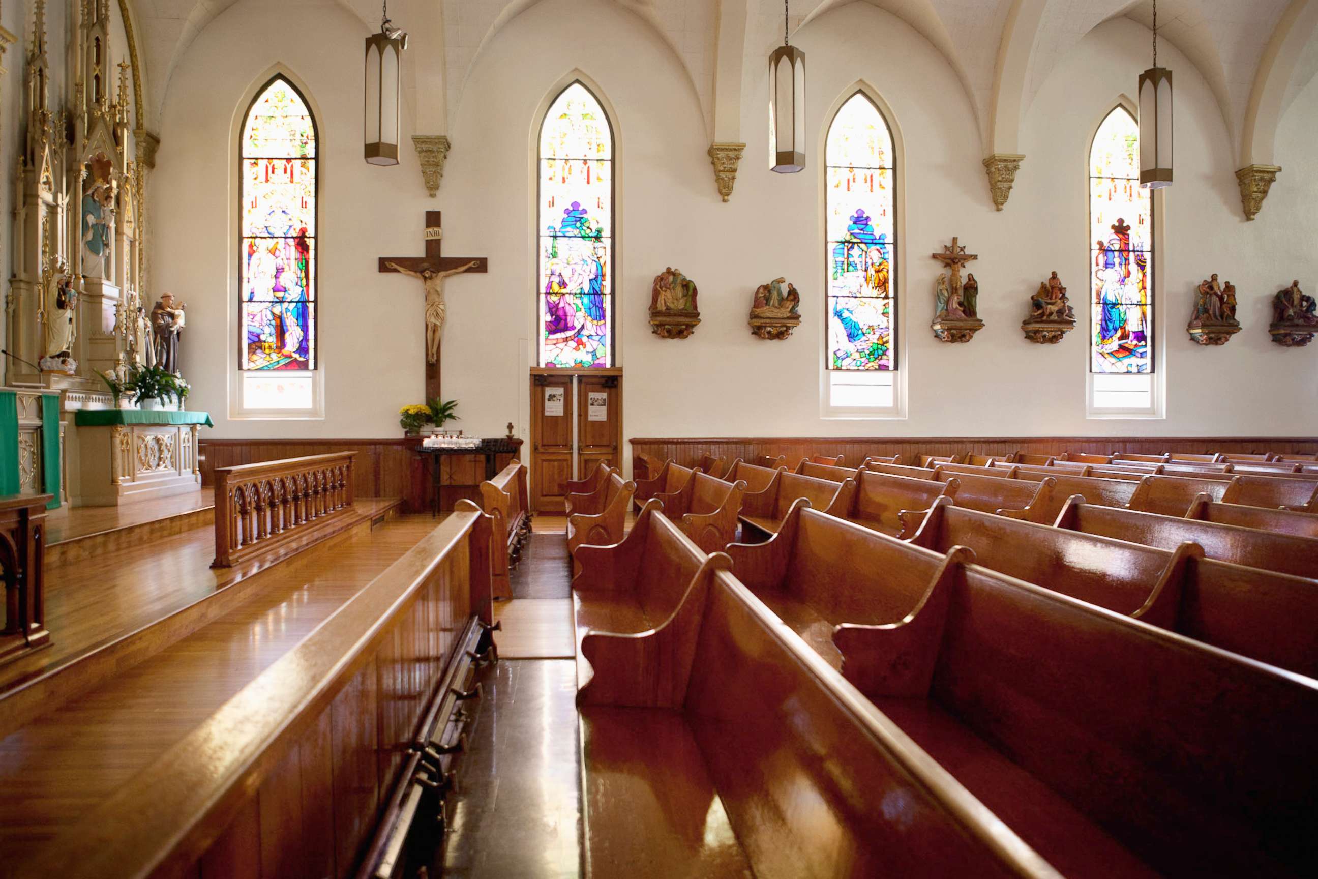PHOTO: An undated stock photo of pews and stained glass windows in a church.