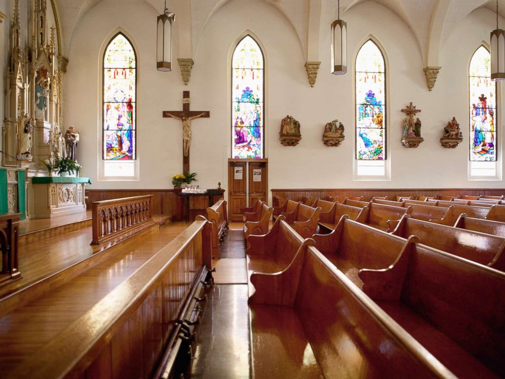 PHOTO: An undated stock photo of pews and stained glass windows in a church.