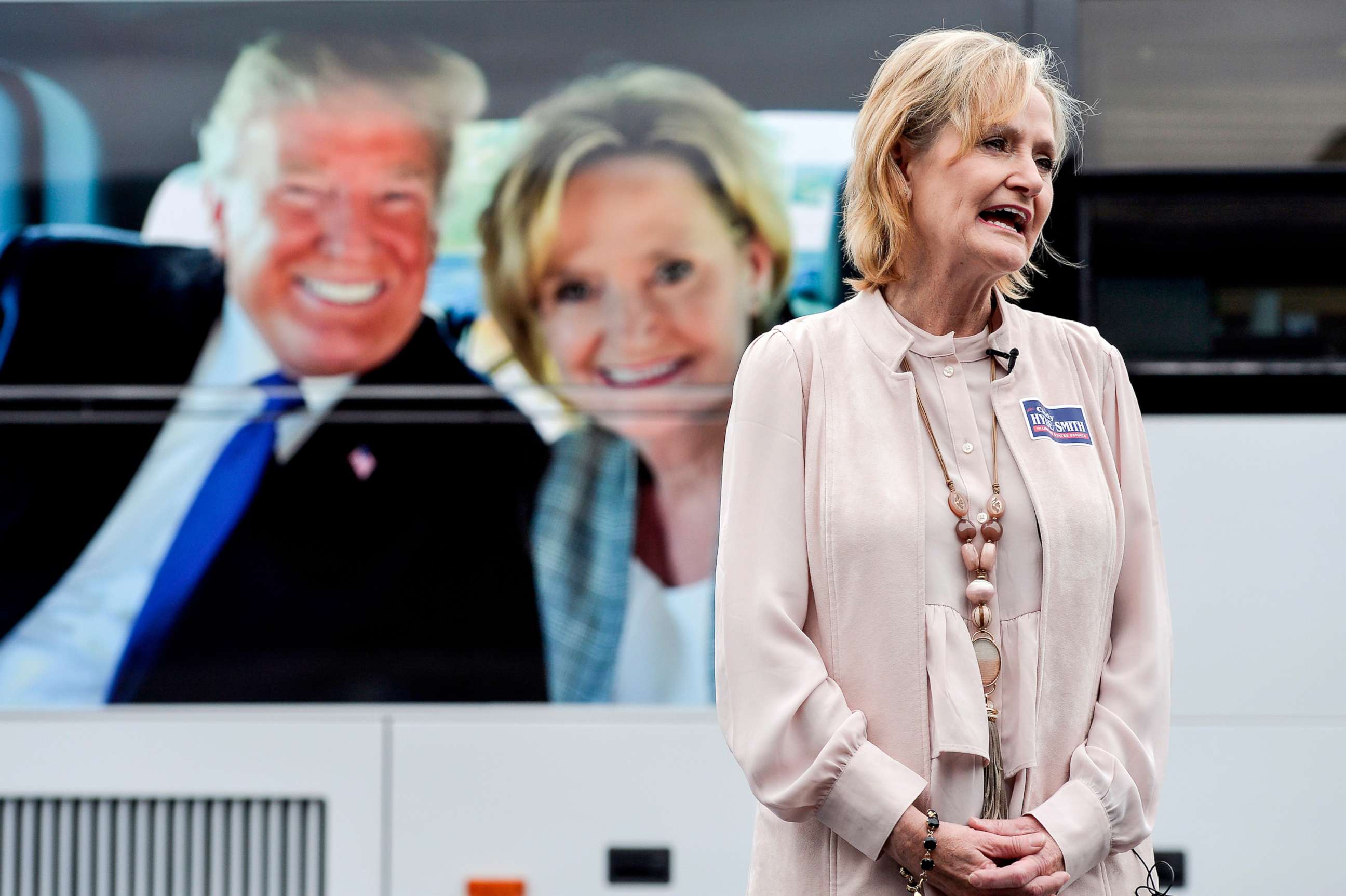 PHOTO: Sen. Cindy Hyde-Smith speaks with a reporter in front of her tour bus, which features a photo of her and President Donald Trump, during a campaign stop in Nesbit, Miss., Oct. 26, 2018.