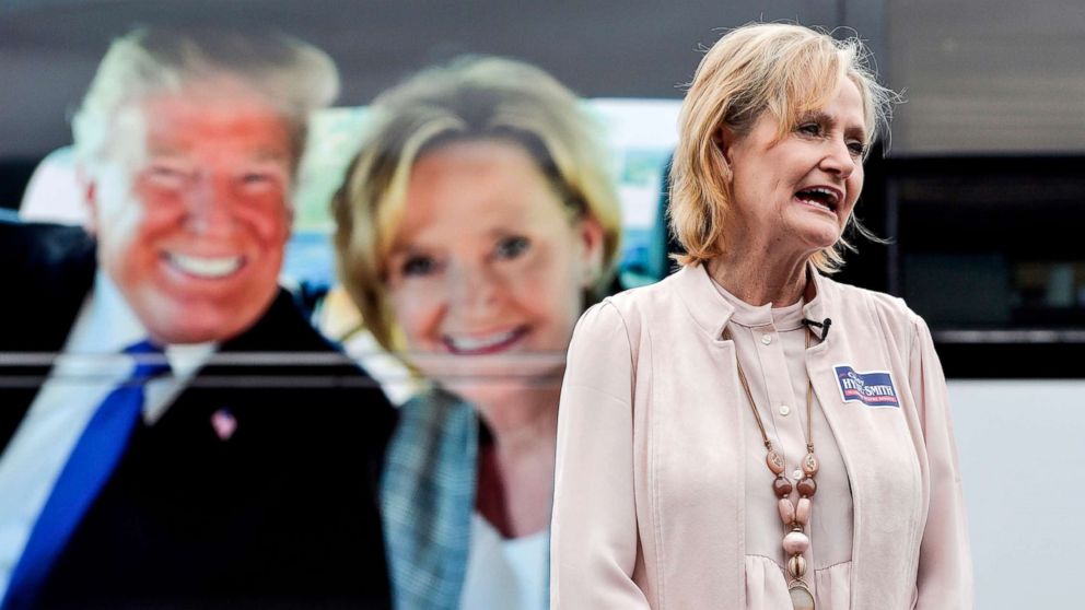 PHOTO: Sen. Cindy Hyde-Smith speaks with a reporter in front of her tour bus, which features a photo of her and President Donald Trump, during a campaign stop in Nesbit, Miss., Oct. 26, 2018.