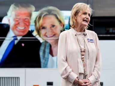 PHOTO: Sen. Cindy Hyde-Smith speaks with a reporter in front of her tour bus, which features a photo of her and President Donald Trump, during a campaign stop in Nesbit, Miss., Oct. 26, 2018.