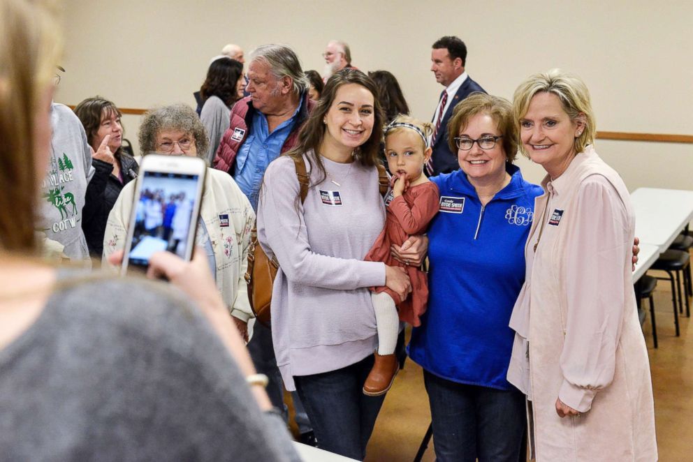 PHOTO: Sen. Cindy Hyde-Smith, right, poses with supporters during a campaign stop at the Northwest Mississippi Association of Realtors office in Nesbit, Miss., Oct. 26, 2018.