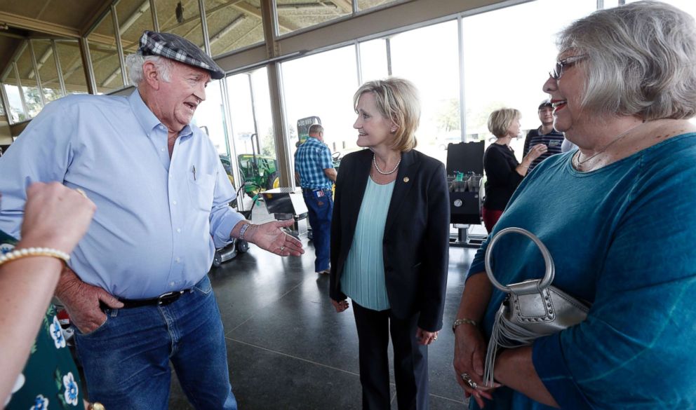 PHOTO: Appointed Sen. Cindy Hyde-Smith listens to cattle farmer Charlie Hull, left, as he tells a story during a campaign stop in Greenwood, Miss., Sept. 7, 2018.