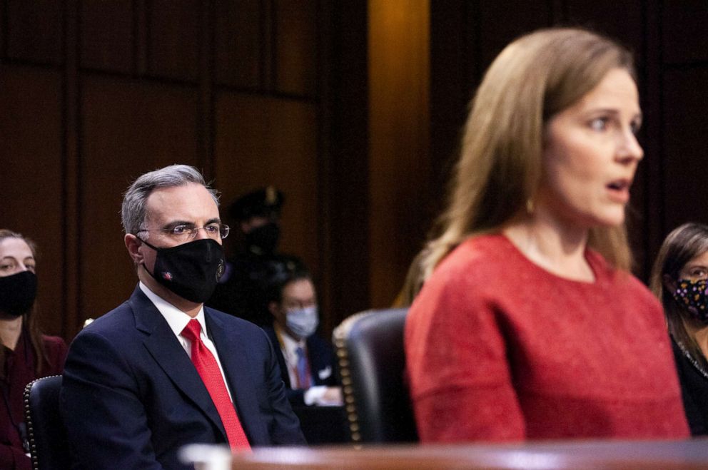PHOTO: White House Counsel Pat Cipollone sits behind Supreme Court nominee Judge Amy Coney Barrett as she testifies before the Senate Judiciary Committee on the second day of her confirmation hearing on Capitol Hill, Oct. 13, 2020, in Washington, D.C.