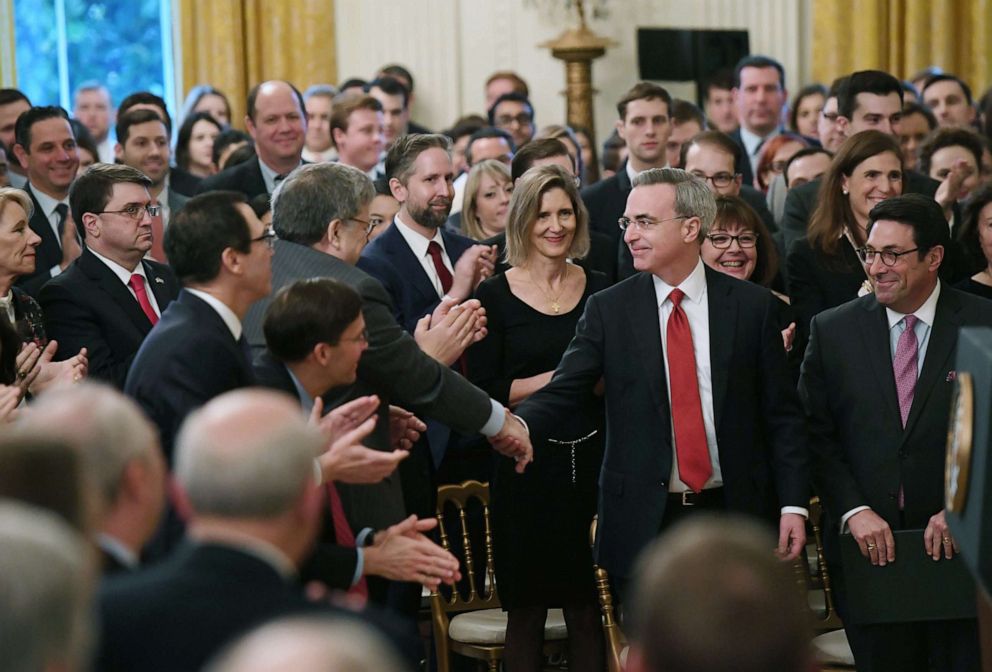 PHOTO: White House defense team lawyer Pat Cipollone, center, shakes hands with Attorney General William Barr before President Donald Trump speaks about his Senate impeachment trial in the East Room of the White House, Feb. 6, 2020.