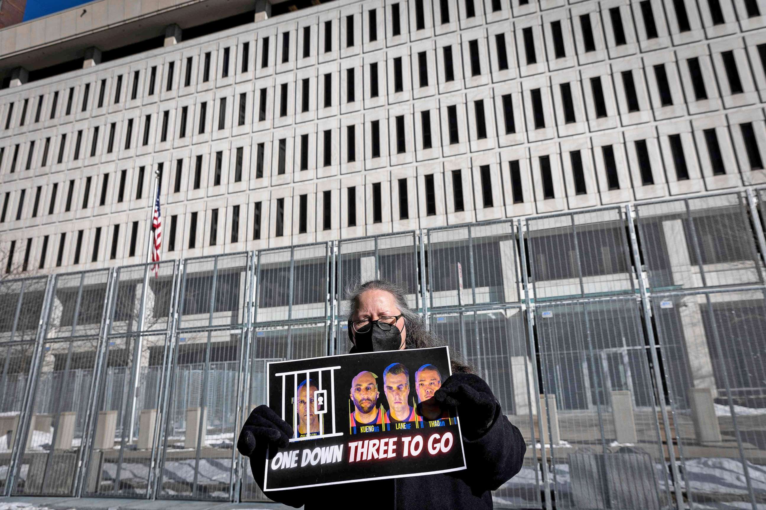PHOTO: A community activist holds a placard during press conference outside the U.S. District Court in St. Paul, Minn., on Jan. 20, 2022, for the jury selection of former police officers charged with federal civil rights violations in George Floyd's death