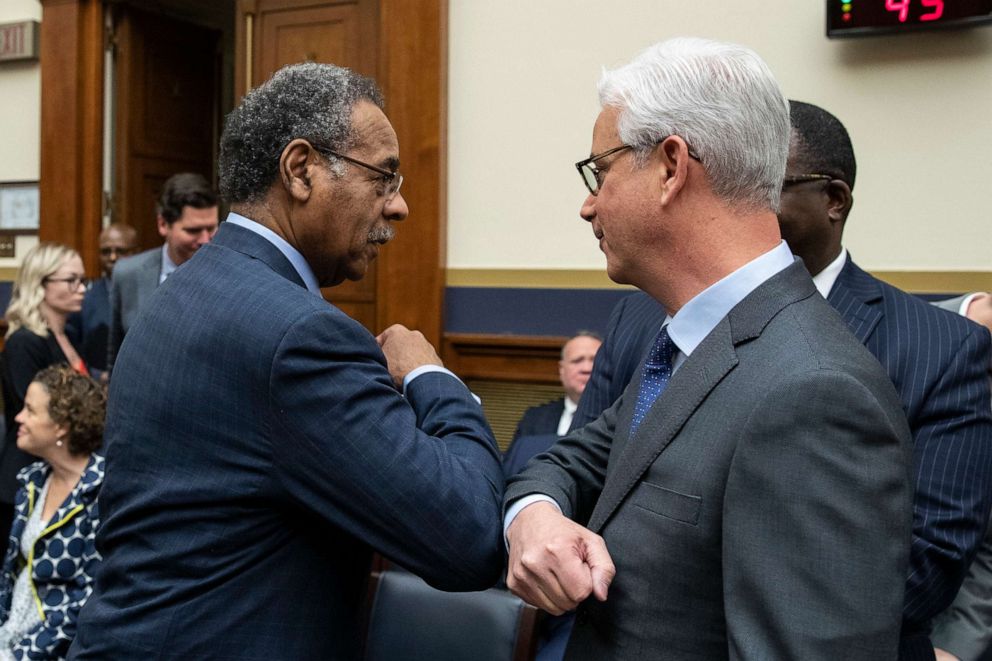 PHOTO: Rep. Emanuel Cleaver, left, rubs elbows with Wells Fargo CEO and President Charles Scharf before he testifies during a hearing of the House Financial Services Committee, on Capitol Hill, March 10, 2020, in Washington.