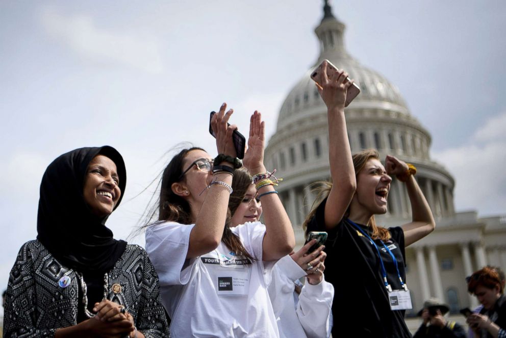 PHOTO: Rep. Ilhan Omar, left, attends a youth climate rally on the west front of the Capitol, March 15, 2019 in Washington, D.C.