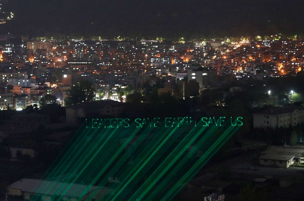 PHOTO: A laser beam show aimed at raising the awareness of climate change risks on the eve of the Leaders Summit on Climate, reads, "Leaders Save Earth Save Us," in Seoul, South Korea, April 21, 2021.