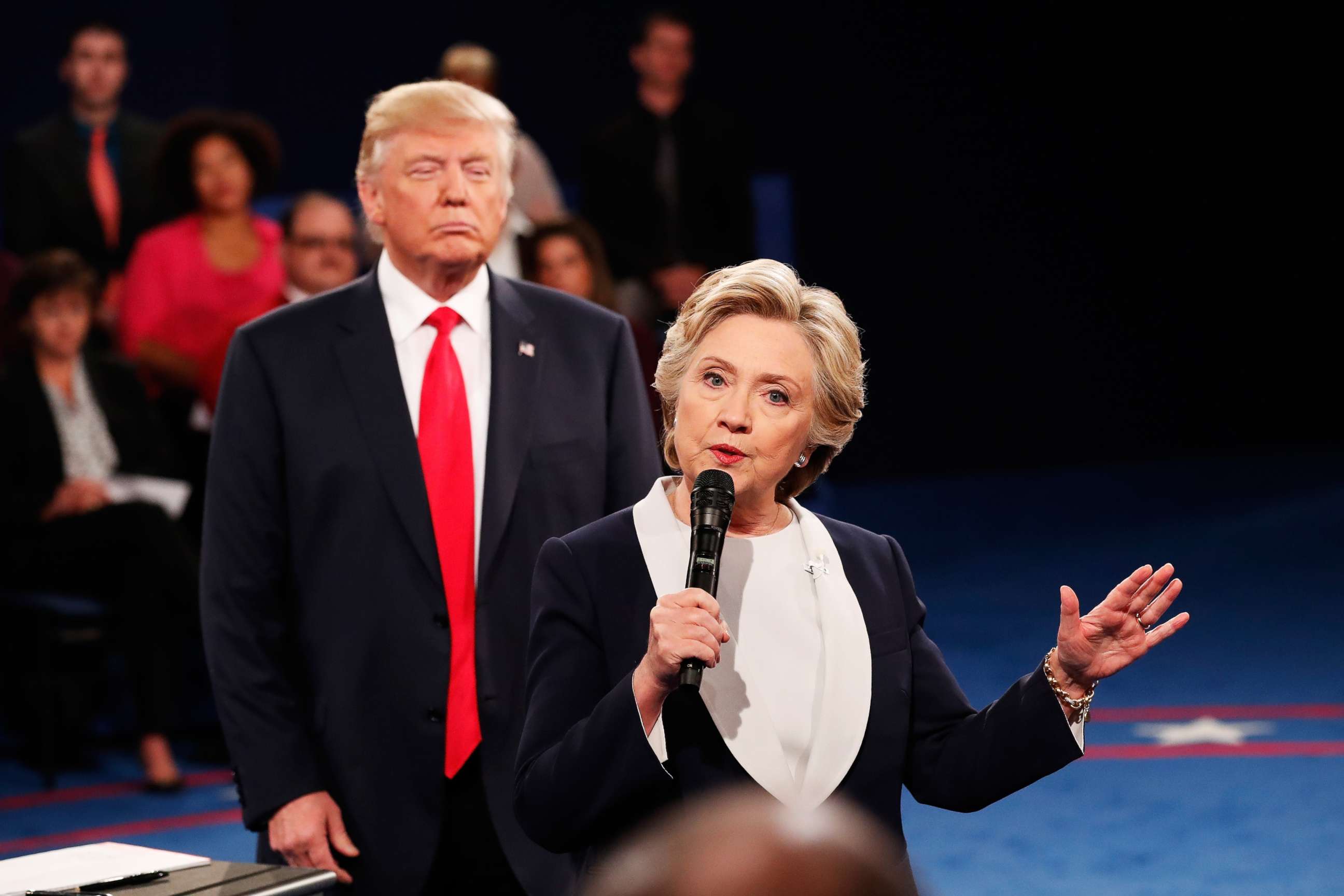 PHOTO: Democratic presidential nominee Hillary Clinton speaks during the second of three debates as Republican presidential nominee Donald Trump looks on at Washington University on Oct. 9, 2016, in St Louis, Missouri. 