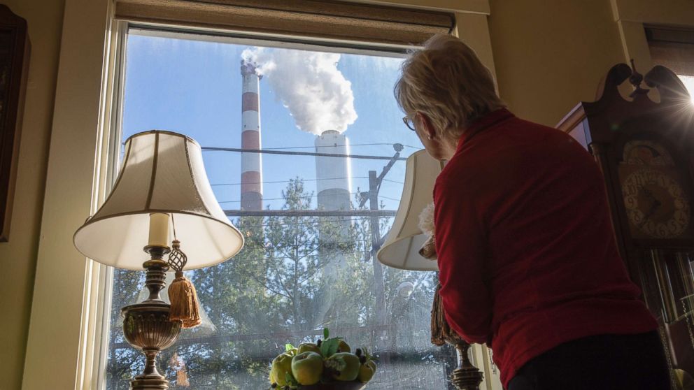 PHOTO: Marti Blake looks out her front window at the smoke stack of the 47-year old Cheswick coal-fired power plant, Oct. 27, 2017 in Springdale, Pa.